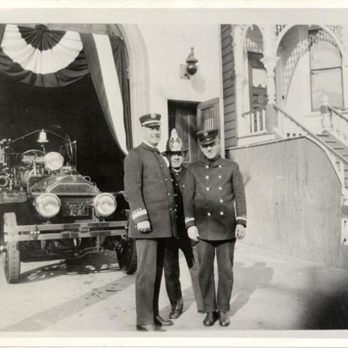 [Three firemen posing in front of the old Engine 44]