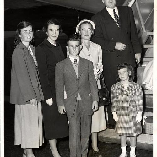 [District Attorney Edmund G. Brown leaving his plane with members of his family]