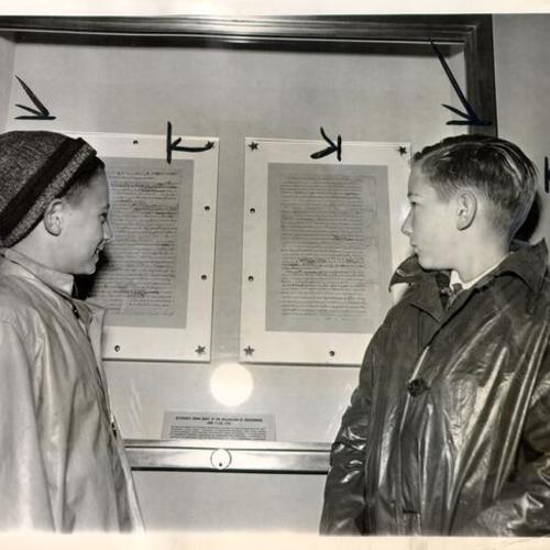 [Donald Dooley and Charlton Buckley looking at Thomas Jefferson's rough draft of the Declaration of Independence in a display case on the Freedom Train]