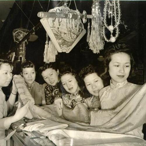 [Six women comparing fabrics to be worn in an annual benefit for St. Mary's Catholic Chinese Social Center]