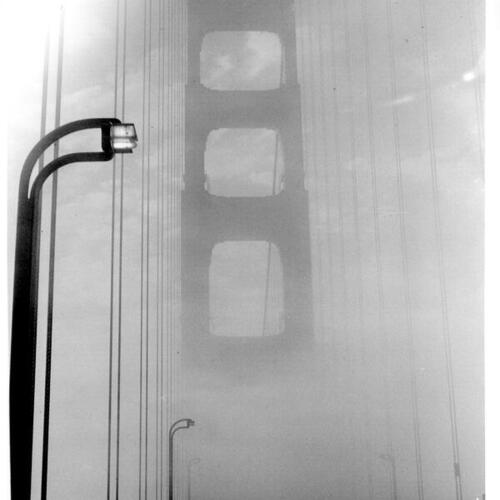 [View of Golden Gate Bridge tower through fog]
