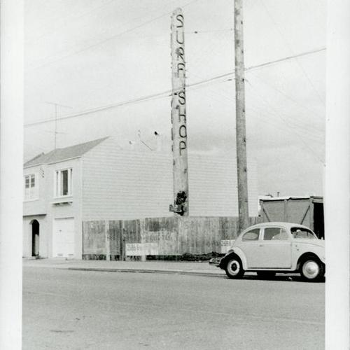 [Jack O'Neill's second surf shop on Great Highway with landmark pole]