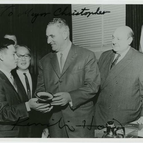 [Kenichi Horie hands compass to Mayor George Christopher with Donald Watson and Consul General Toshio Yamanka]