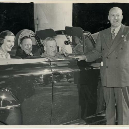 William L. Hughson Company manager Earl Dalem (right) with to Jane (left), George, and William L. Hughson in Mercury convertible