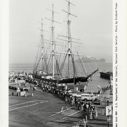 [People waiting on line to view the sailing ship "Balclutha" at Fisherman's Wharf]