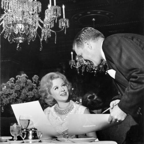 [Waiter Anthony Pels taking an order from Mary Corta in the Cafe Medallion at the St. Francis Hotel]