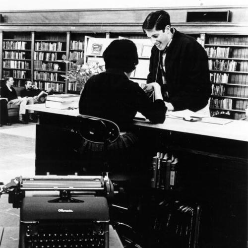 [Librarian helping a patron in the Literature Department at the Main Library]