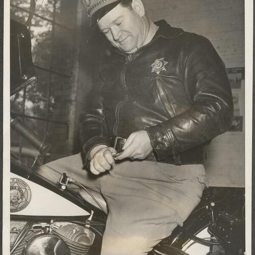 George Stinson in uniform on California Highway Patrol motorcycle