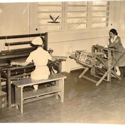 [Nurse Corinne Parsons and occupational therapist Mary Rixford examining equipment at Langley Porter Clinic]