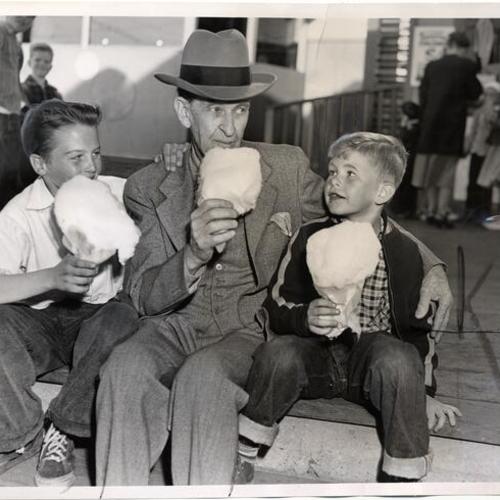 [Charles Coryell with his grandson Ronnie Nunan and friend david bacon at Playland at the Beach]