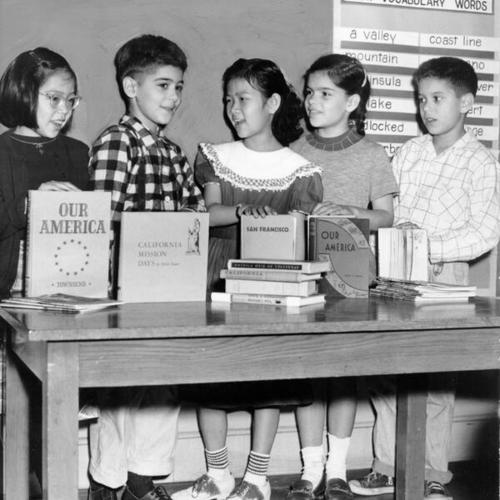 [Fourth grade students at Garfield School with social studies books]