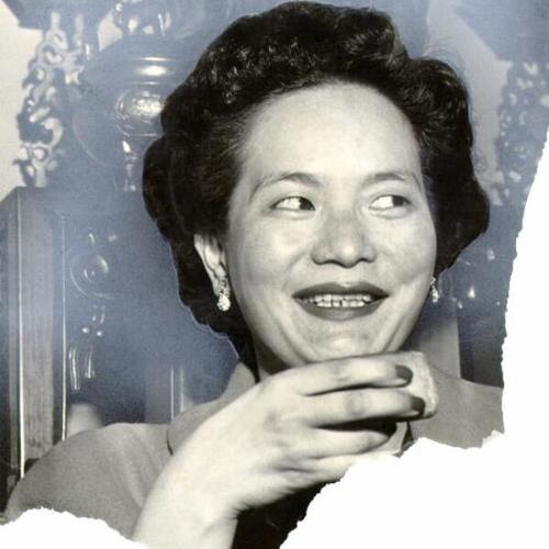 [Mrs. Albert Y. Young tasting a moon cake at Hang Far Low, Chinatown's oldest restaurant]