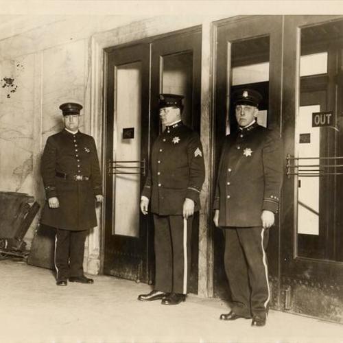 [Officer Joseph Coleman, Sergeant Peter A. MacIntyre and Officer William Brudigan inside the hall of Justice]