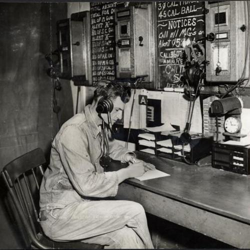 [Unidentified man sitting at a desk at the Army's Communication Center in the Presidio]
