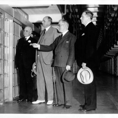 [San Francisco Mayor Angelo Rossi, United States Attorney General Homer S. Cummings, Warden James A. Johnston and San Francisco Chief of Police Quinn tour Alcatraz Island prison]