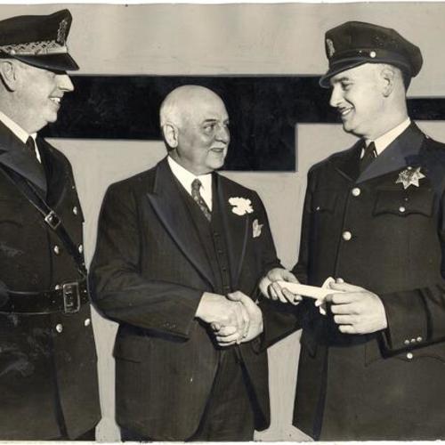 [Police Chief William Quinn (left), Mayor Rossi and Officer J.D. Thornley at award ceremony for rookies]