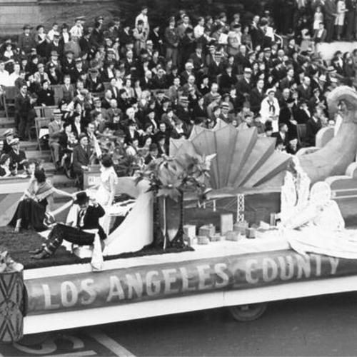 [Float, sponsored by Los Angeles County, passing by spectators in the opening day celebration parade for San Francisco-Oakland Bay Bridge]