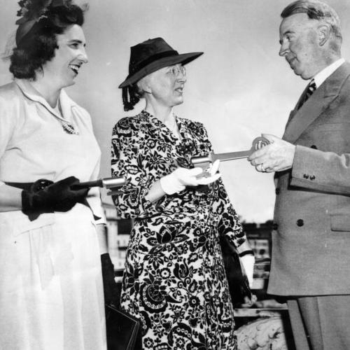 [Thomas A. Brooks presents the key to the city to Miss Margaret Connors and Mrs. Chase Woodhouse]