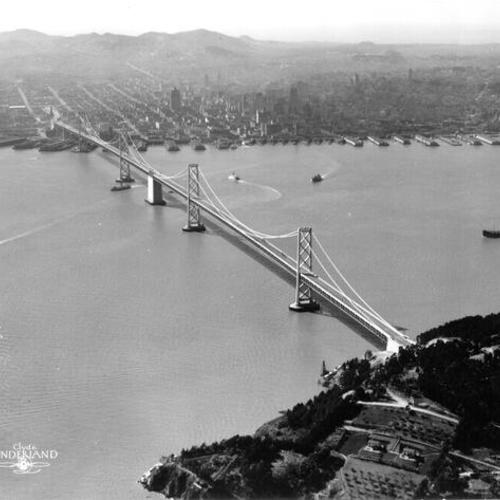 [Aerial view of suspension section of Bay Bridge and downtown San Francisco]
