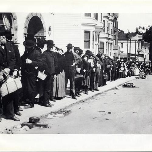 [Refugees standing in a bread line on Clayton Street]