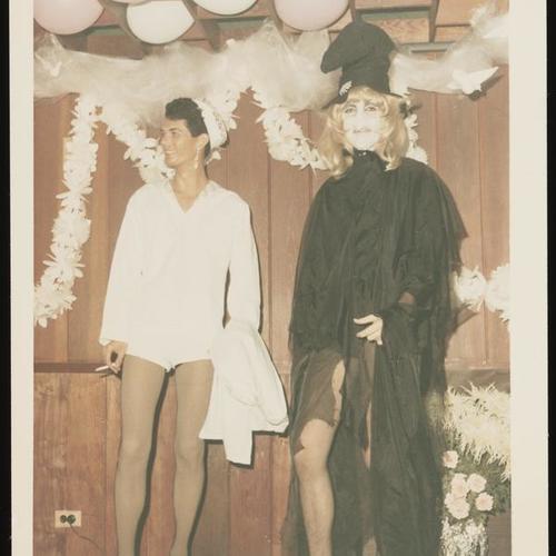 Portrait of two people on stage, one in witch costume