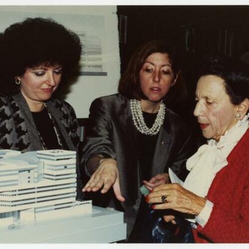 Marjorie Stern (right) with others looking at model of the new Main Library