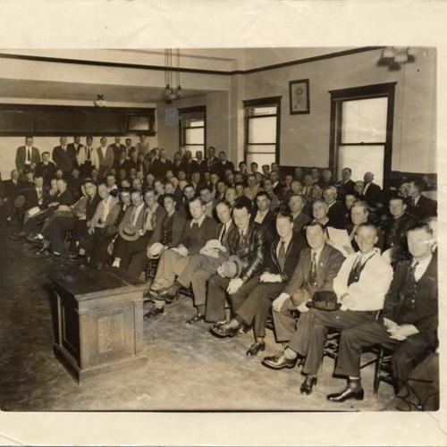 [Streetcar workers at a union meeting]