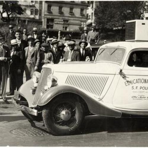[Pedestrians observing the San Francisco Police Department's educational car at Portsmouth Plaza]