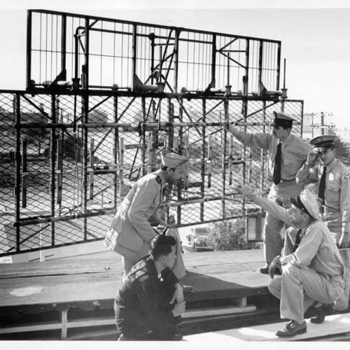 [Four foreign students at the U. S. Naval School of Electronics, Treasure Island, receiving instruction in the maintenance of an exterior antenna]