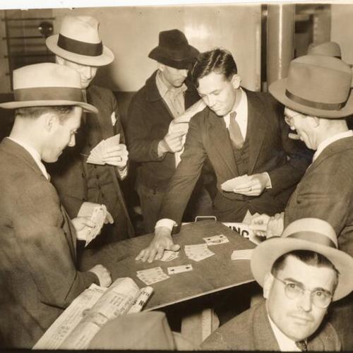 [Group of ferryboat commuters playing cards]