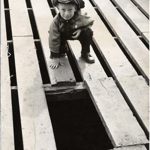 [Glen Fahs posing next to a hazardous opening on a platform erected to cover a storm sewer at Glen Park Playground]