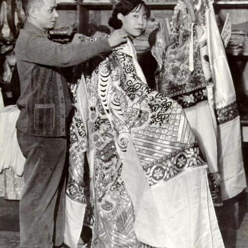 [Actress Leon Bo Lun getting dressed for a performance at the Chinese Theater in Chinatown]