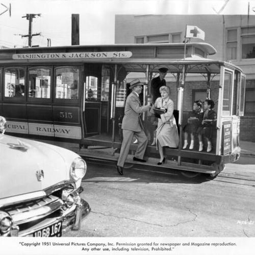[Alex Nicol and Shelley Winters on Washington Street and Jackson cable car in scene from the film "The Raging Tide."]