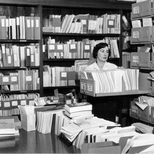 [Government documents librarian Phyllis Joseph sorts through files]