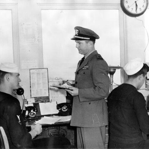 [Signalman Carl J. Waller, Lieutenant John G. Worth and Signalman John Grosse at the Navy's lookout and signal station on Yerba Buena Island]