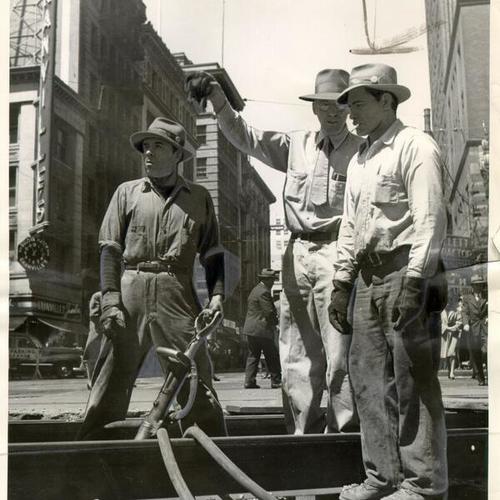 [Construction men working on the rail replacement project on Market near Kearny Street]
