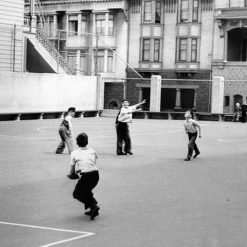 [Children playing baseball in playground of John Muir School]