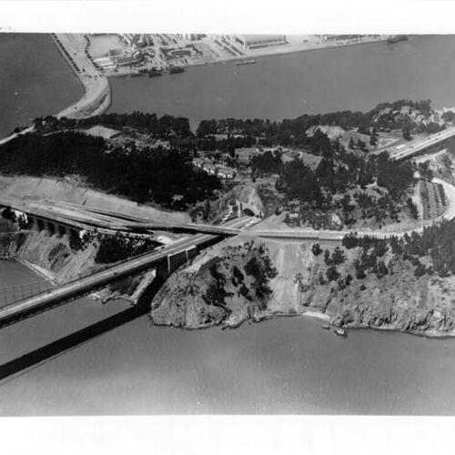 [Aerial view of Yerba Buena Island detailing west tunnel entrance with Treasure Island in background]
