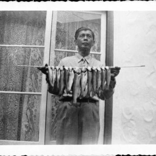 [Melinda's grandfather with trout fish caught from Lake Merced]