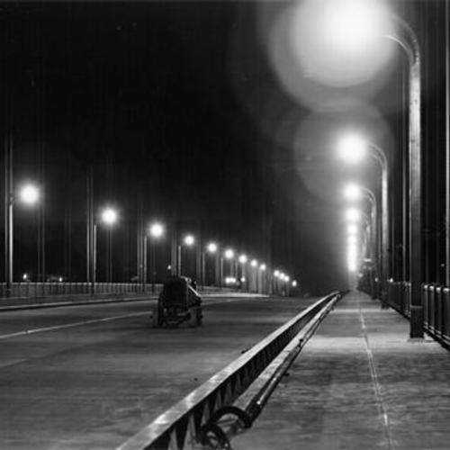 [Golden Gate Bridge at night, several days before official opening]