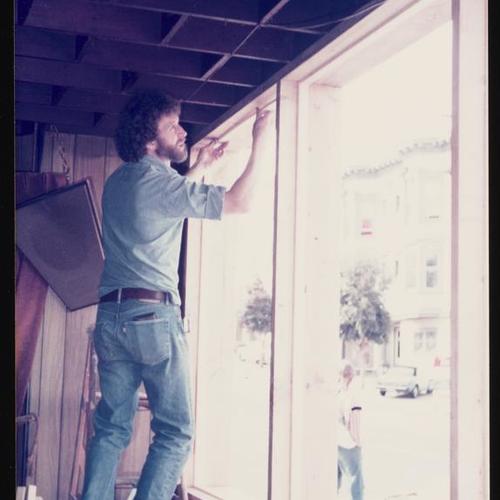 Bartender John Swindle installing new window