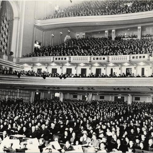 [Audience singing "Peace on Earth, Good Will Toward Men" at the War Memorial Opera House on Christmas evening, 1939]