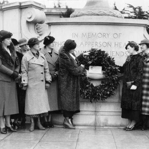 [Women laying a wreath on the Phoebe Apperson Hearst Monument in Golden Gate Park]