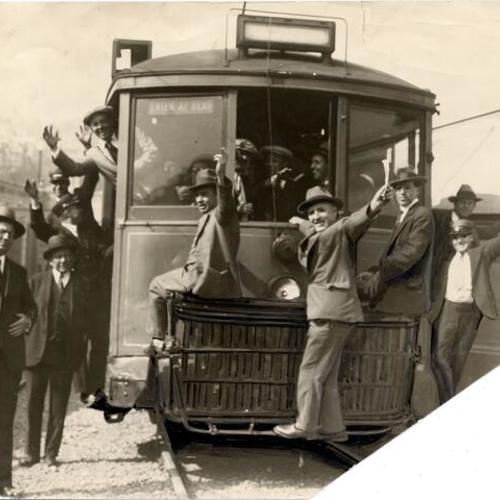[Group of men posing with a Municipal Railway streetcar]