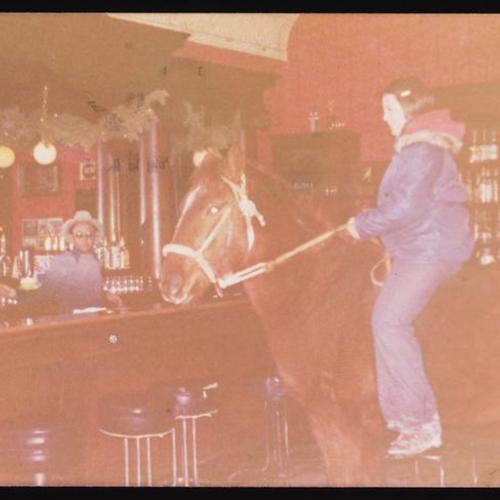 Person on horseback inside Bearcreek Saloon