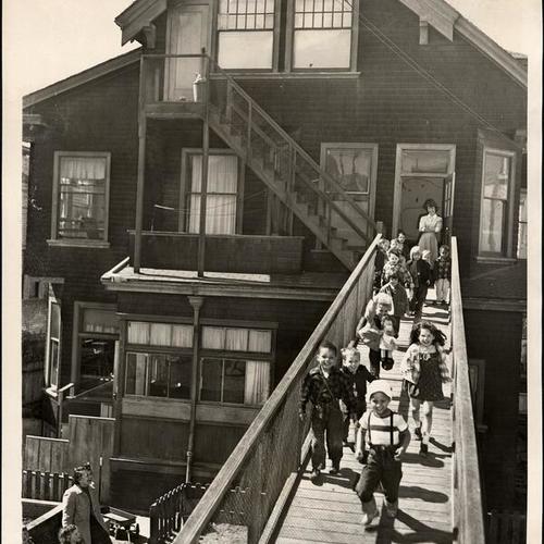 [Children running down a ramp in the back of the Presidio Hill Nursery School]
