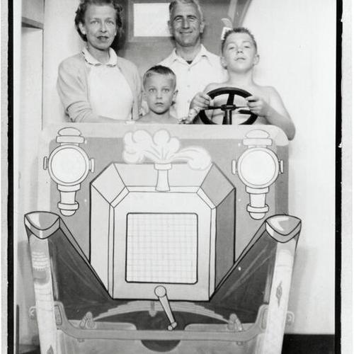 [A family at Santa Cruz boardwalk in Summer of 1955]