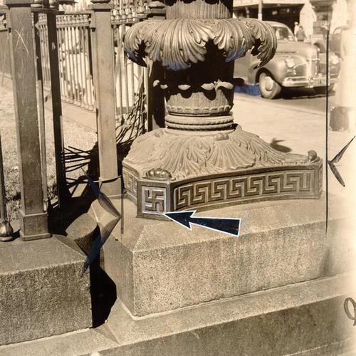 [Arrow indicating swastika on the base of the lamp outside old Mint building at Fifth and Mission street]