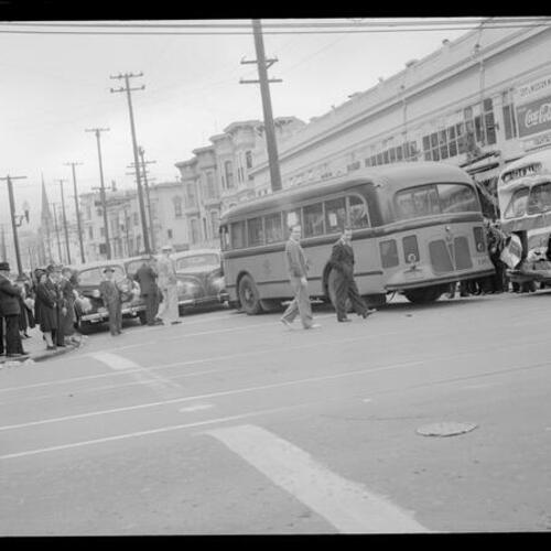 [Crowd looks on at collision of Muni bus and Greyhound bus,