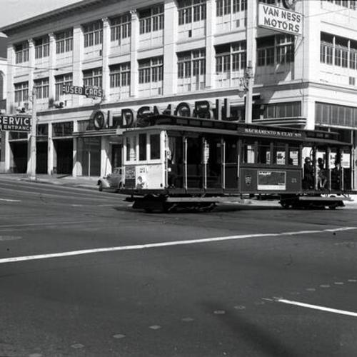 [Sacramento Street and Van Ness avenue looking northeast at Sacramento and Clay cable car line #21 crossing Van Ness outbound]